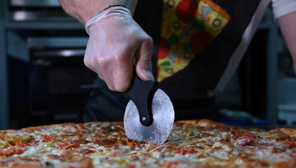 Pizza wheel cuts pizza