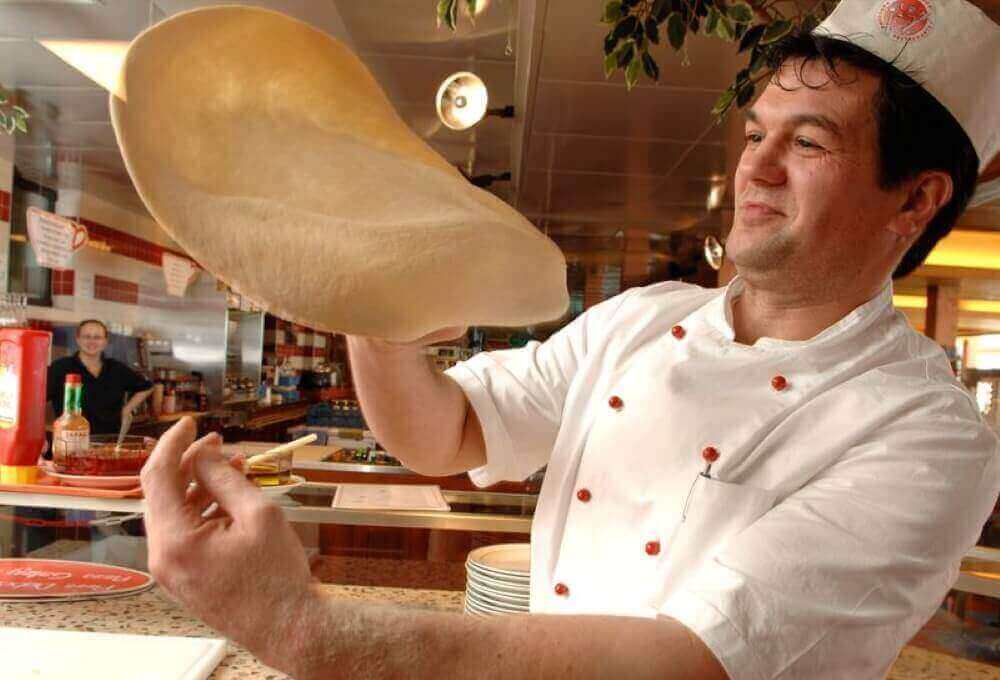 rolling pizza dough in hands