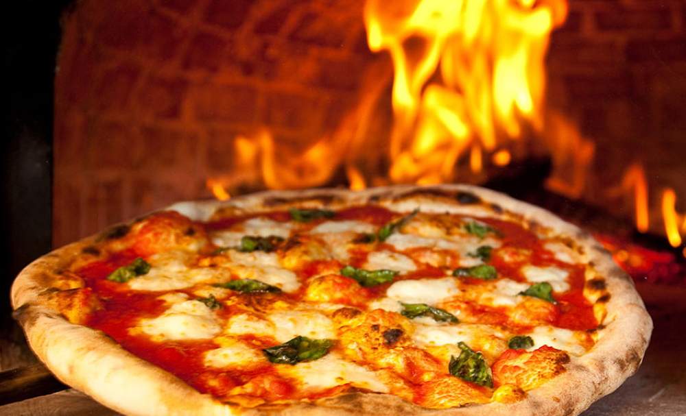 pizza in a deep wood-burning oven